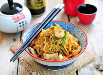 Pork roast with rice noodles, carrots, zucchini, garlic, ginger, green onions, with rice vinegar, soy sauce and sesame oil.
