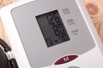 automatic blood pressure monitor on a wooden background