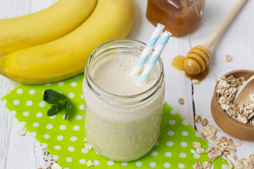Banana smoothies in a glass jar on a white background