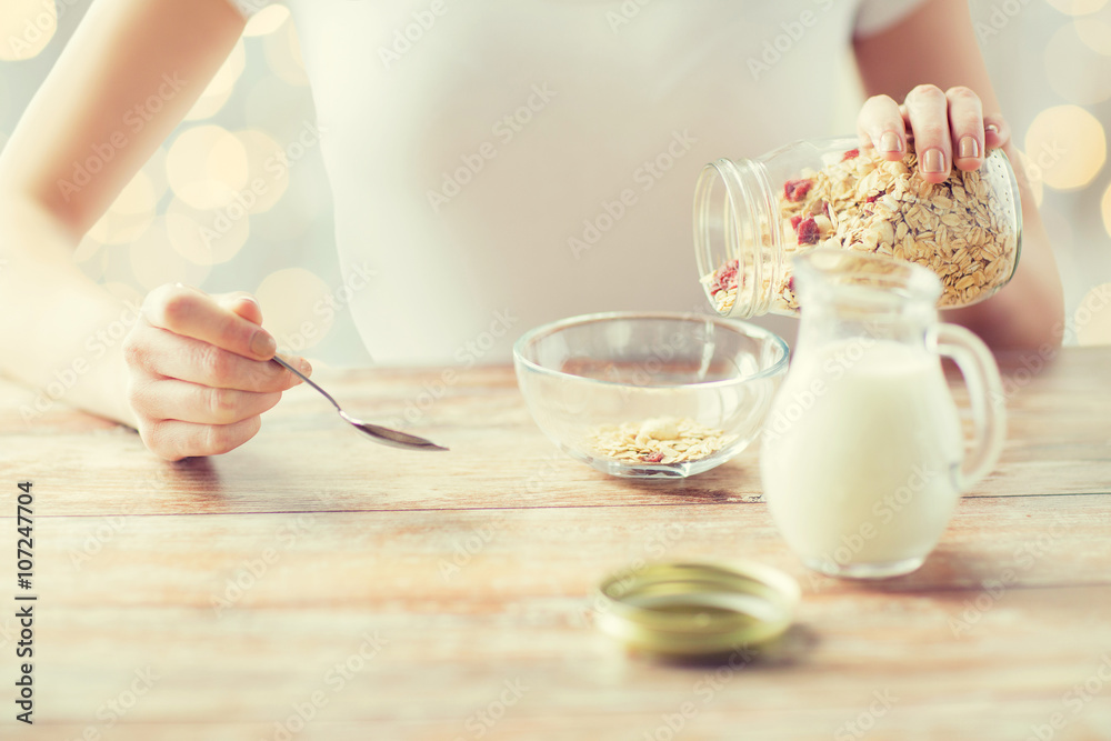 Wall mural close up of woman eating muesli for breakfast