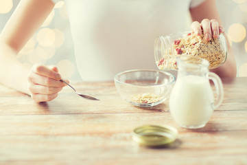 close up of woman eating muesli for breakfast