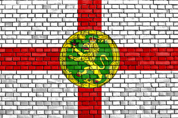 flag of Alderney painted on brick wall
