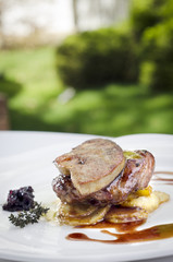 veal with potatoo served on white plate