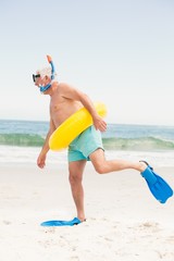 Senior man with swimming ring and flippers at the beach © WavebreakMediaMicro