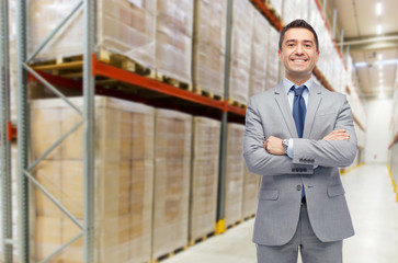 happy man in suit and tie over warehouse