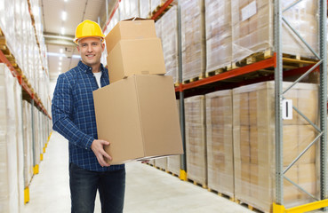 happy man or loader with box at warehouse