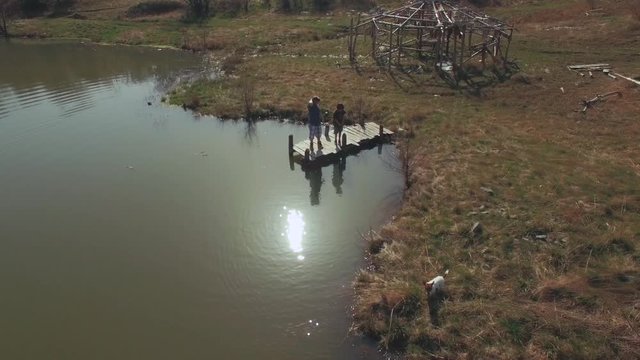 Boys and dog playing / aerial video