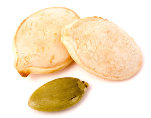 two pumpkin seeds on white background macro