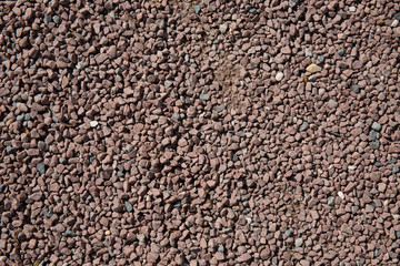 Surface covered with the red gravel as a background texture