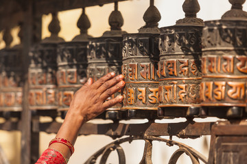 Tibetan prayer wheels or prayer's rolls of the faithful Buddhist - obrazy, fototapety, plakaty