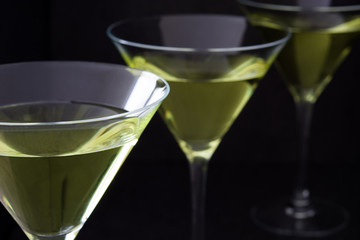 Green apple cocktail on black stone background
