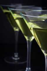 Green apple cocktail on black stone background
