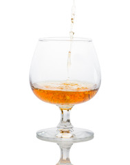a glass of brandy on a white background.