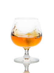 a glass of brandy on a white background.