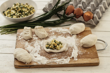 Preparing for the Russian pies, filling of the room (eggs and green onions) in the test of yeast. Pies - the traditional fried rolls stuffed with a set of fillings.