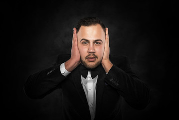 Obraz premium Man covering his ears.