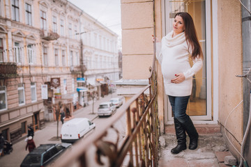 Beautiful pregnant woman on the balcony