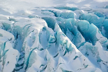 Foto auf Acrylglas Details of the glacier Svinafellsjokull at winter, blue vivid textured ice covered by snow, Iceland © dash1502