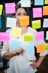 Businesswoman looking at sticky note