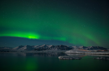 Fototapeta na wymiar Aurora Borealis or Northern Lights over the glacier lagoon Jokulsarlon, Iceland