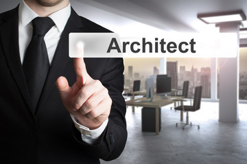 businessman in modern office pushing virtual button architect