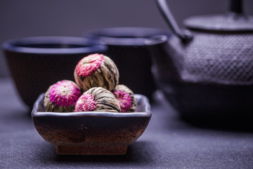 Chinese green tea balls with flowers, tea cup