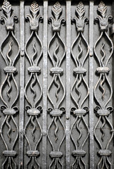Vintage texture of a metal surface with decorative wrought iron elements.