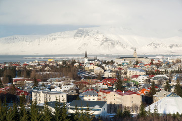 Obraz premium Aerial view of Reykjavik from Perlan, snow capped mountains during winter sunset, Iceland
