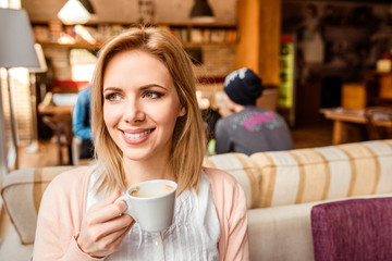 Woman in cafe drinking coffee, enjoying her espresso