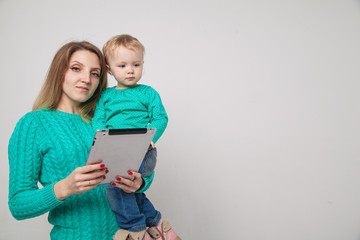 Mother and baby with tablet pc on a white background