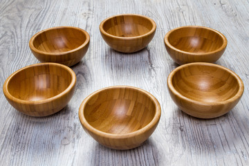 Top view of wooden bowl on wooden background