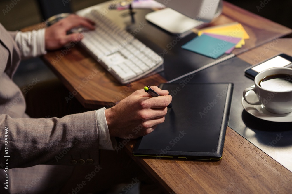 Aufkleber Creative businessman using computer and graphic tablet
