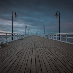 Beautiful landscape with wooden pier in Gdynia Orlowo at sunrise.