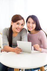 Fototapeta premium Two young woman use of digital tablet pc