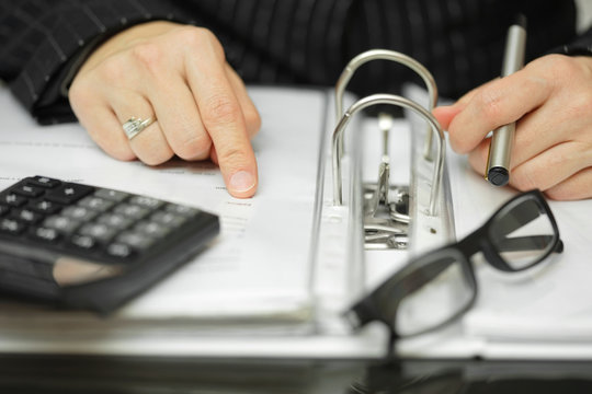 Closeup Of Businesswoman  Hands analyzing financial data