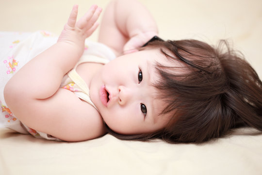 Asian baby girl on the bed