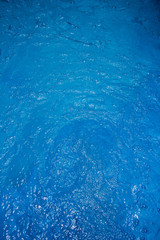 Pool blue with the reflection of sunlight and air bubbles in cle