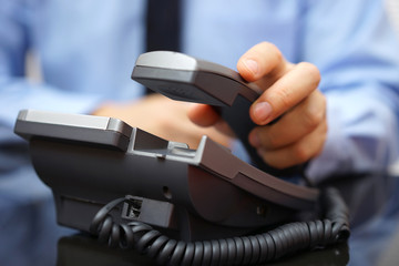 businessman is picking up telephone handset, customer service