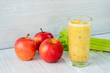 Smoothies made from apples and celery in a glass on the table
