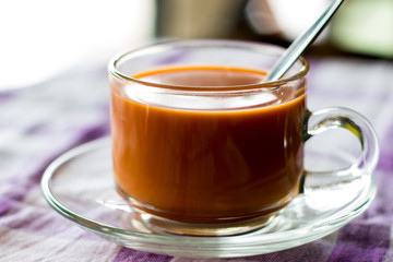 hot milk tea in glass cup on a table