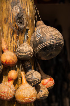 African Maasai carved water gourds hanging on post