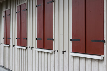 wooden house exterior with closed window shutters