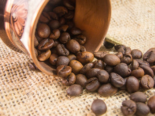 coffee cup with coffee beans on hemp bag texture