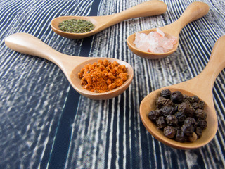 wooden teaspoons with fresh assorted spices