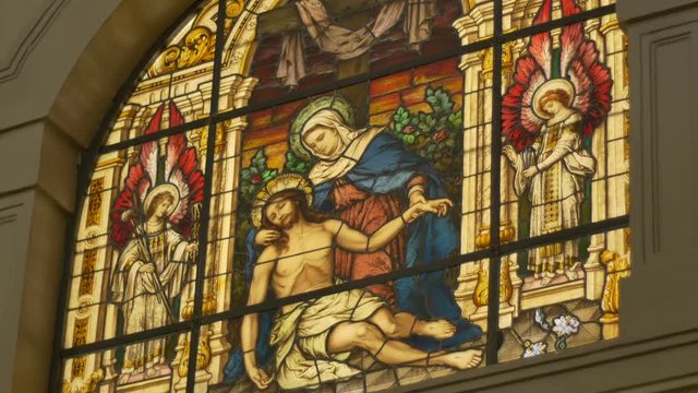 Beautiful colorful stained glass depicting Jesus and Saint Marym in a catholic church.
