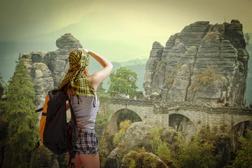 Acrylic prints Bastei Bridge woman traveling with a backpack.