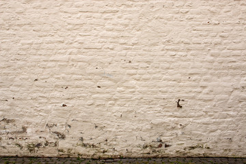 Hintergrund - grob verputzte gelbe Ziegelsteinmauer