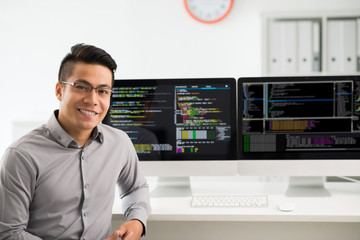 Portrait of smiling young Vietnamese software engineer - obrazy, fototapety, plakaty