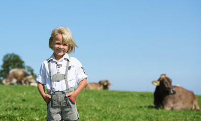 Happy  little bavarian boy on a country field  during Oktoberfest in Germany