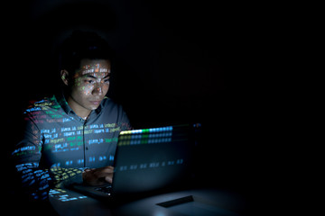 Software developer coding on his laptop at night - obrazy, fototapety, plakaty